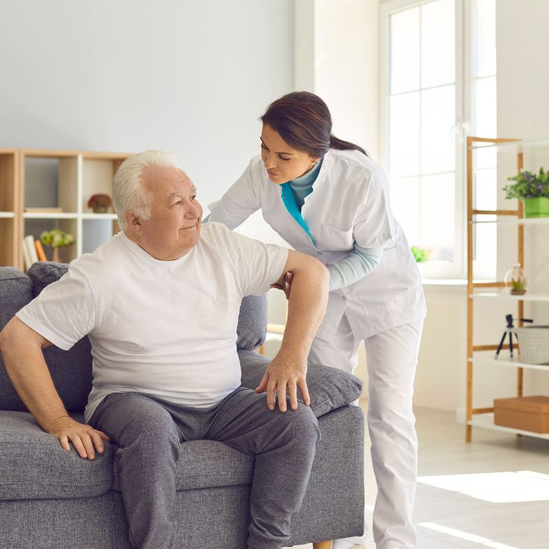 Care worker assists elderly man at home — NDIS Short-Term Respite Service in Sydney with personalised daily living support.